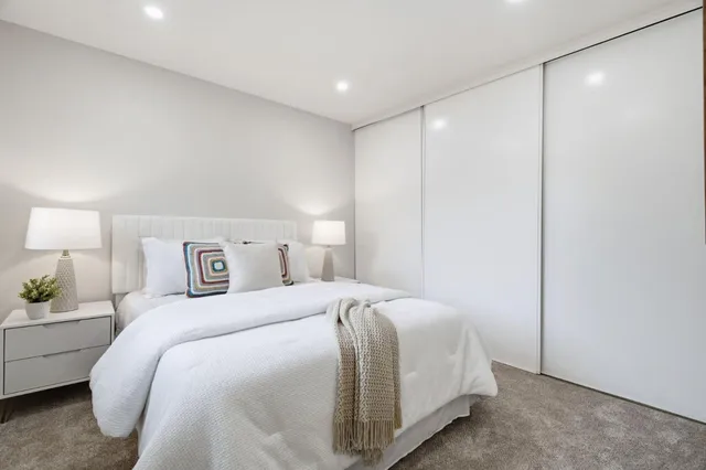 a bedroom with a bed and a night stand