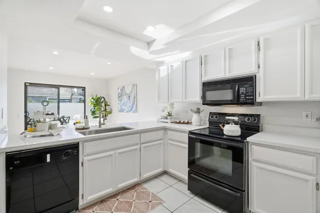 a kitchen with a sink stove and microwave