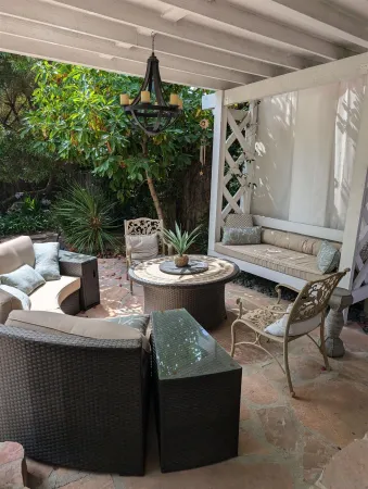 a view of a patio with glass top table and chairs