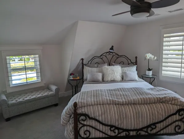 a bedroom with a bed and window