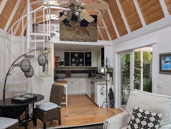 a living room with furniture a flat screen tv and a floor to ceiling window