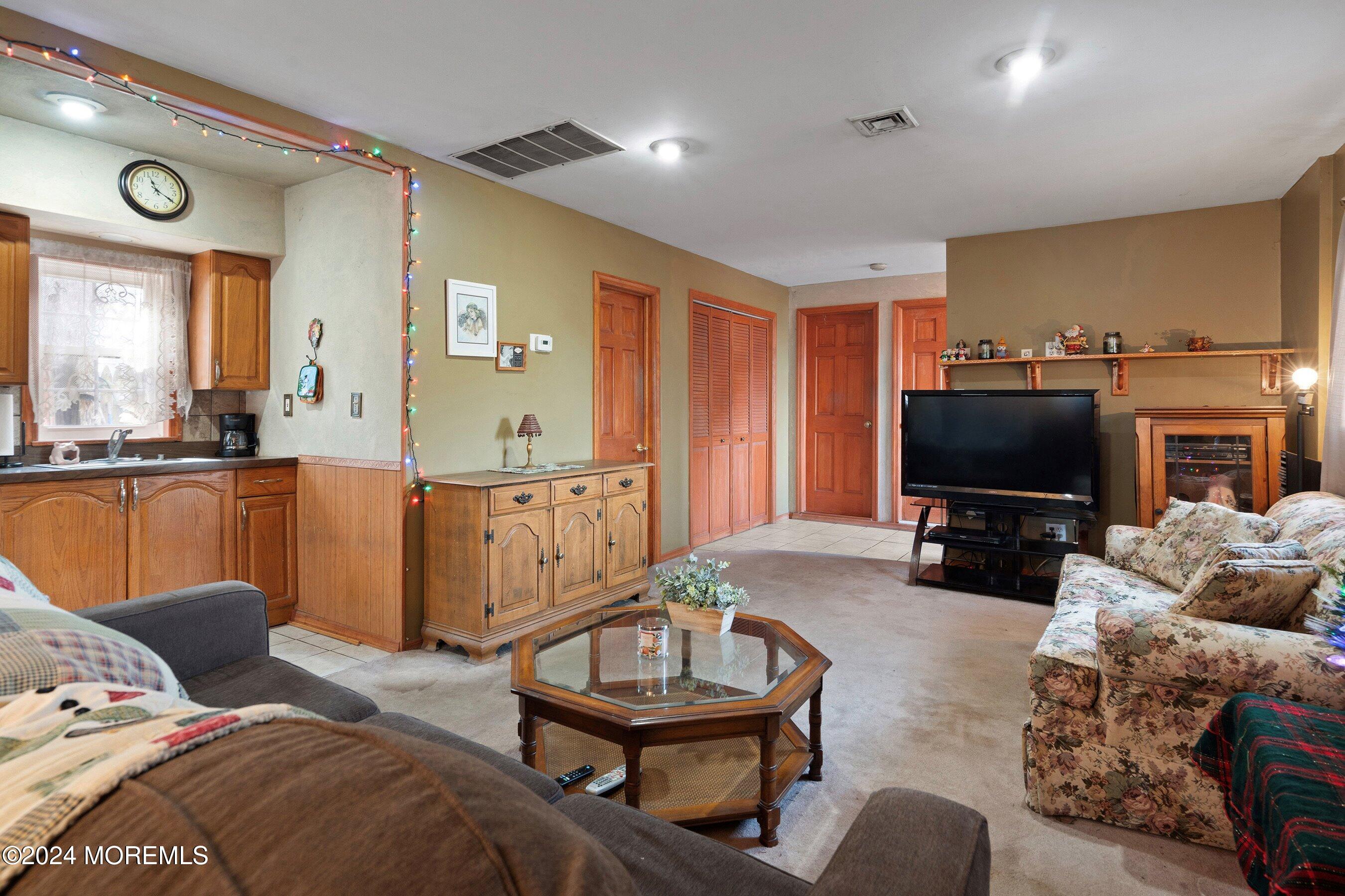 170 Cherry Quay Road Brick, NJ 08723 - Photo 12 of 28 a living room with furniture a large window and a flat screen tv