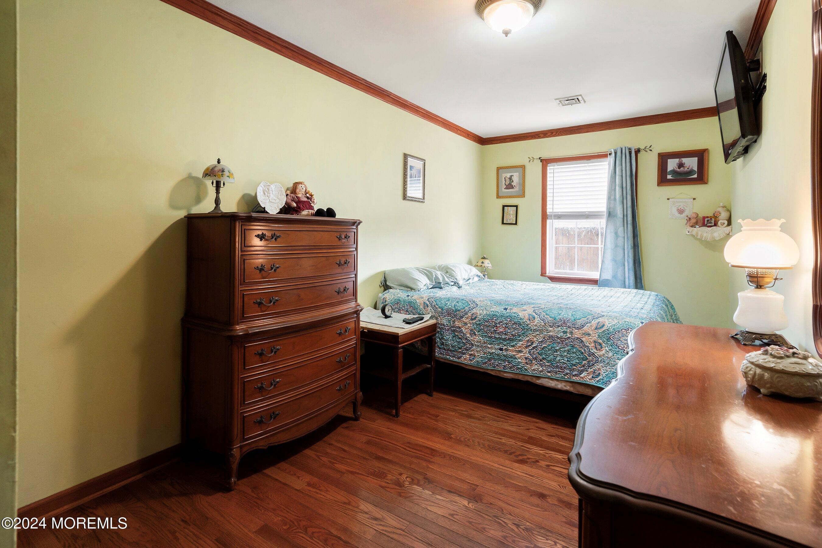 170 Cherry Quay Road Brick, NJ 08723 - Photo 14 of 28 a bedroom with a bed and wooden floor