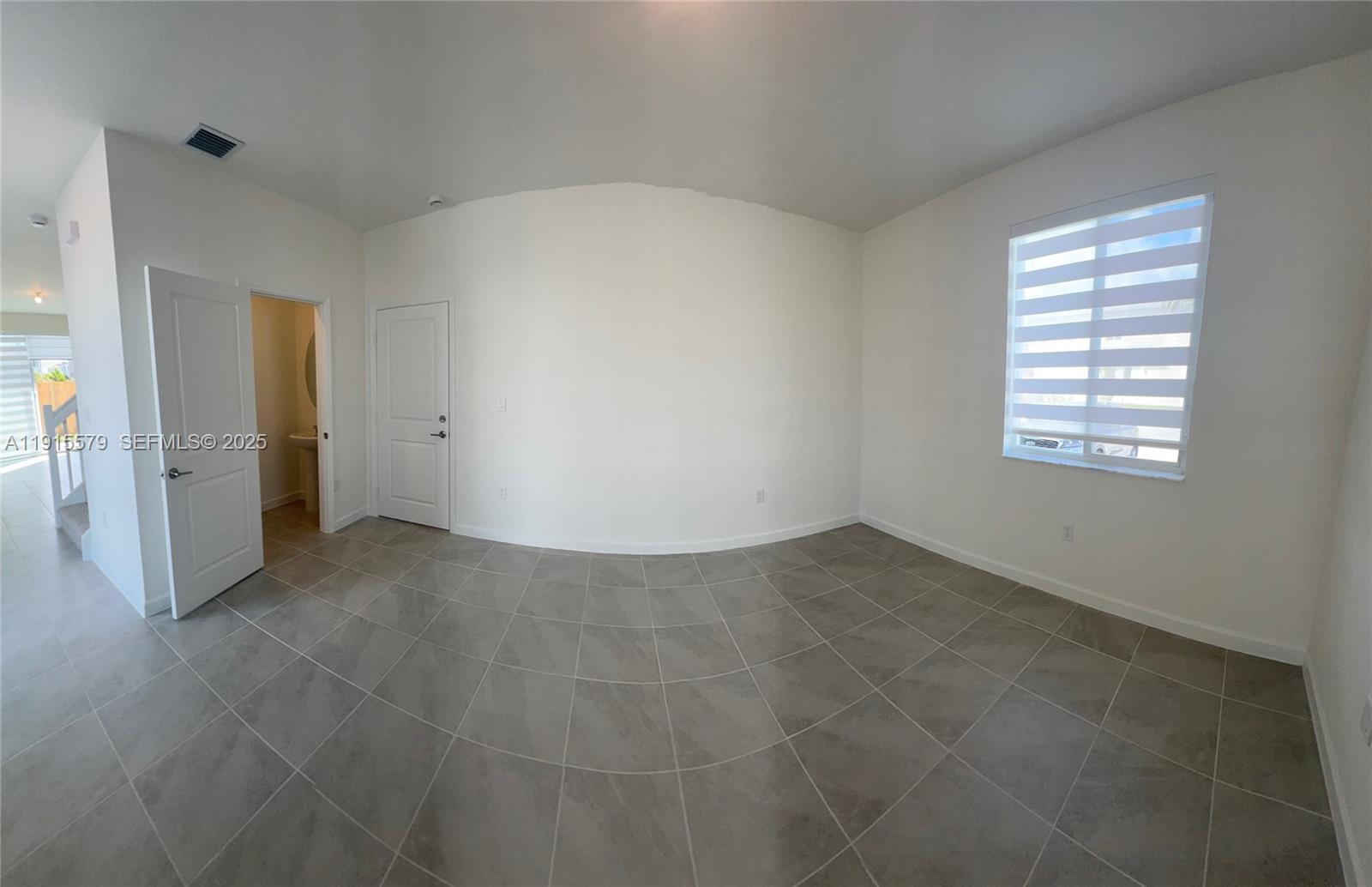 1455 Southeast 6th Terrace Homestead, FL 33034 - Photo 6 of 16 an empty room with windows