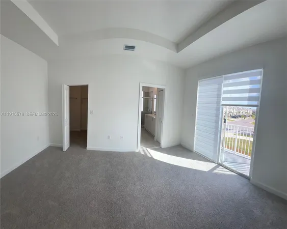 a view of empty room with floor to ceiling window