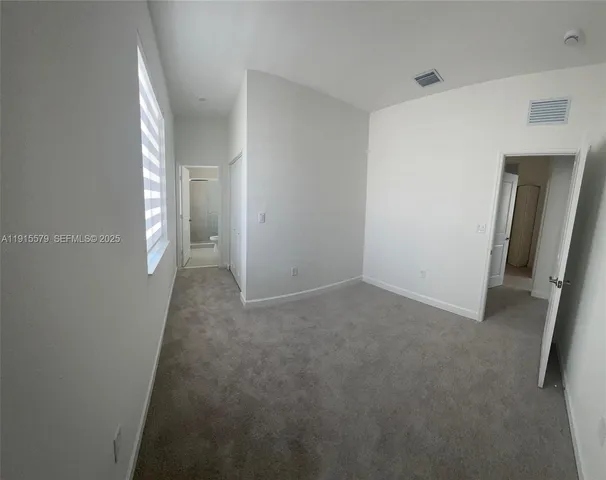 a bathroom with a shower sink vanity and toilet