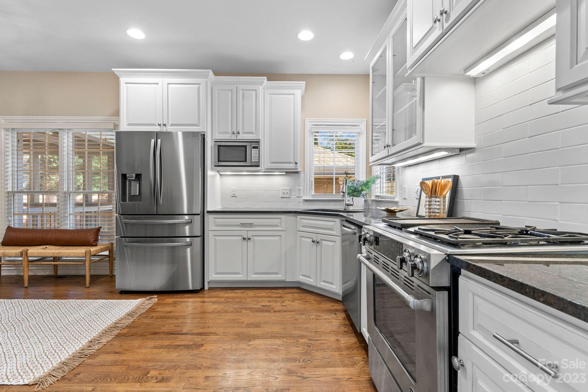 916 Millbrook Road Charlotte, NC 28211 - Photo 8 of 41 a kitchen with stainless steel appliances granite countertop a stove refrigerator and microwave
