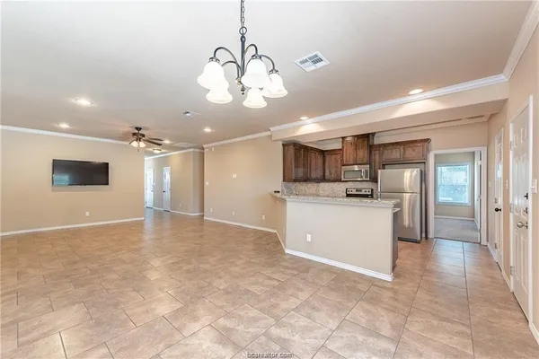 a view of a kitchen with a sink stainless steel appliances and cabinets