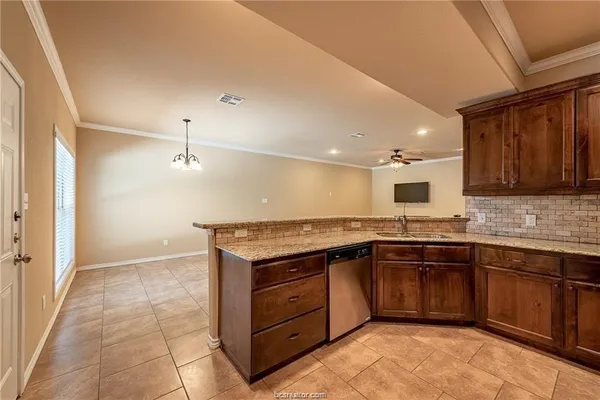 a kitchen with a sink a stove and cabinets