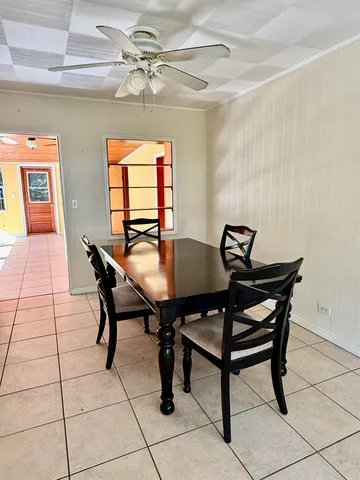 a view of a dining room with furniture and a chandelier