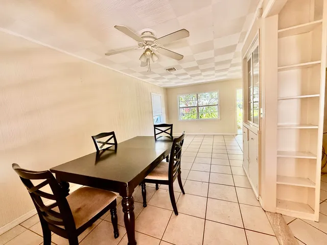 a view of a dining room with furniture and a chandelier