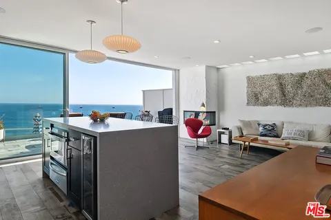 a living room with dining room and wooden floor