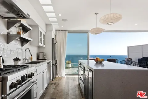 a kitchen that has a lot of cabinets in it