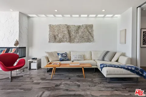 a living room with furniture and a chair