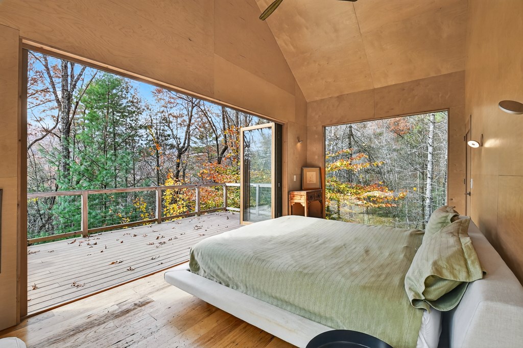 175 Big Creek Road Cherry Log, GA 30522 - Photo 13 of 40 a bed sitting in a bedroom next to a large window