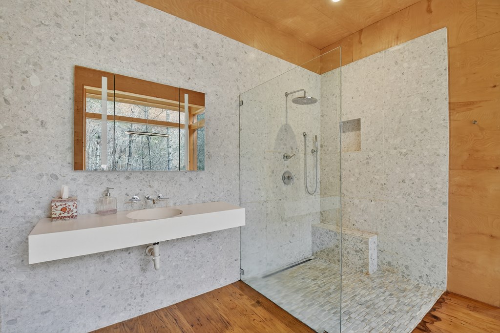 175 Big Creek Road Cherry Log, GA 30522 - Photo 18 of 40 a bathroom with a sink a mirror and shower