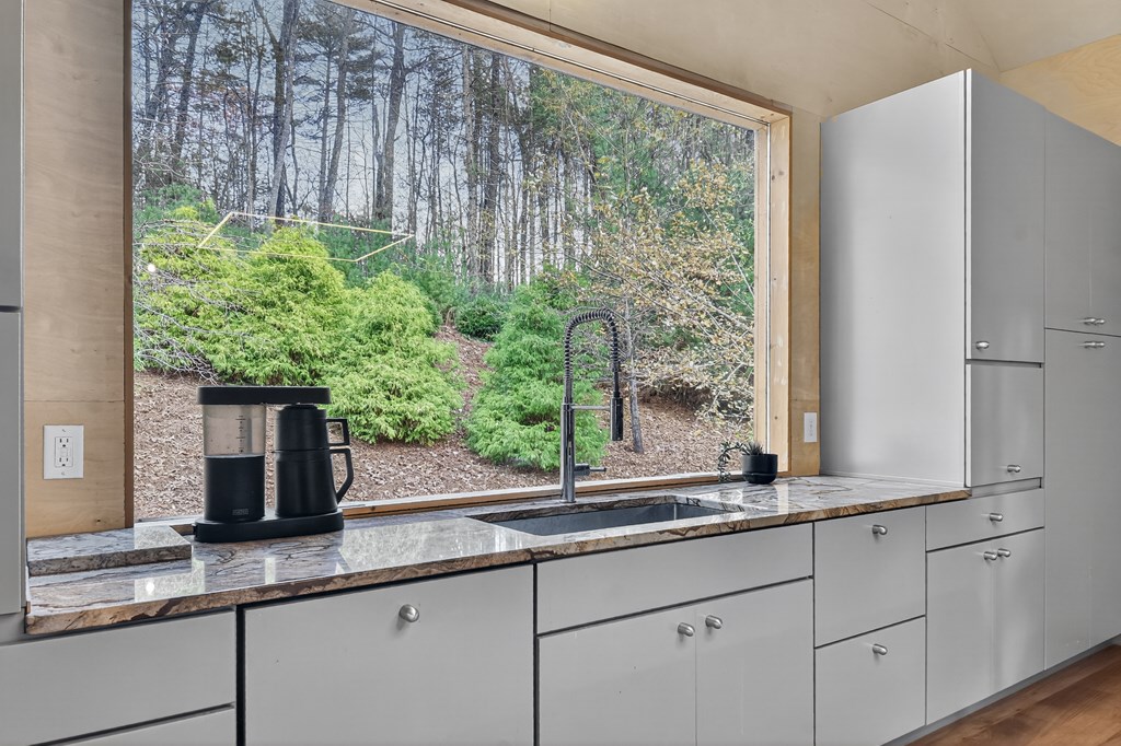 175 Big Creek Road Cherry Log, GA 30522 - Photo 21 of 40 a kitchen with granite countertop a large window and a sink