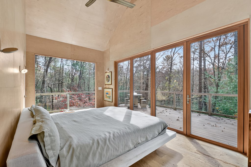 175 Big Creek Road Cherry Log, GA 30522 - Photo 29 of 40 a bedroom with a large bed and a balcony view