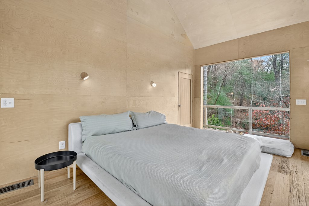 175 Big Creek Road Cherry Log, GA 30522 - Photo 30 of 40 a bedroom with a bed and a large window