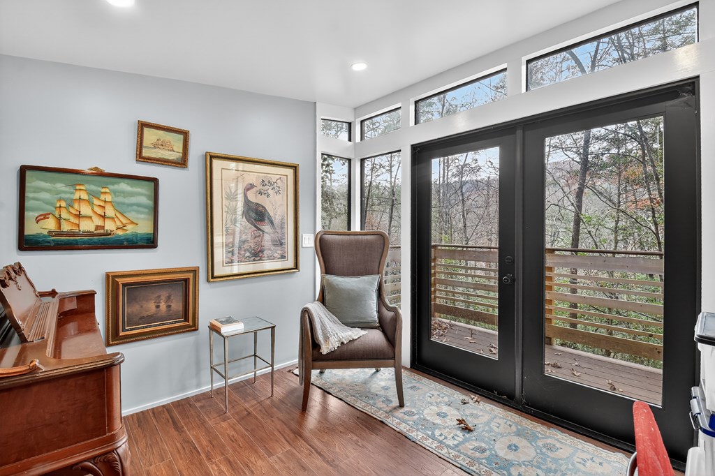175 Big Creek Road Cherry Log, GA 30522 - Photo 40 of 40 a living room with furniture a flat screen tv and a floor to ceiling window