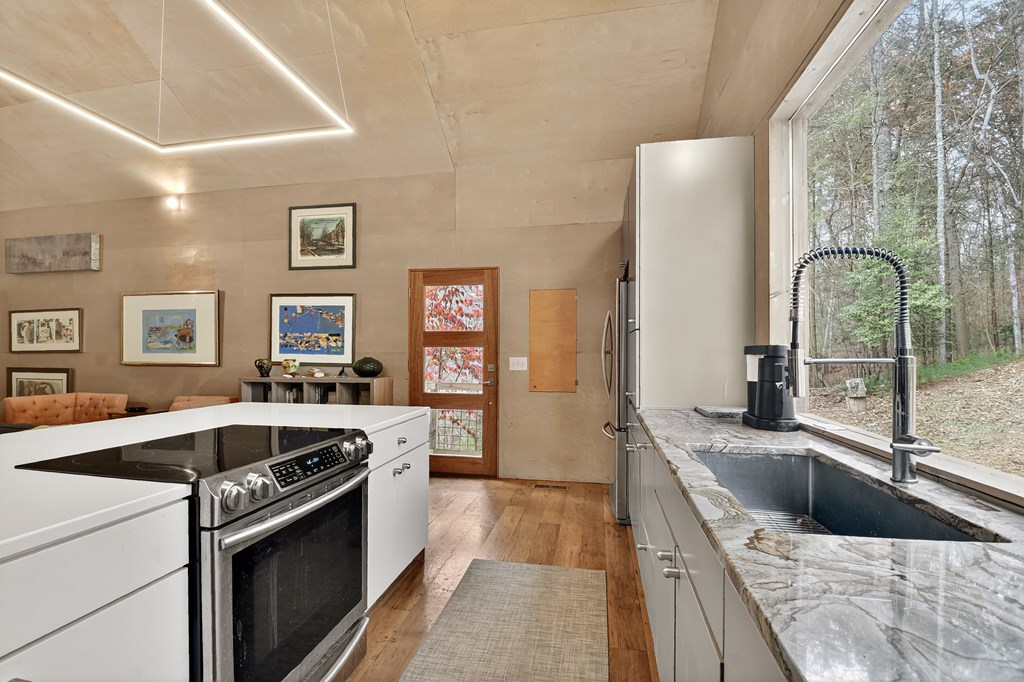 175 Big Creek Road Cherry Log, GA 30522 - Photo 5 of 40 a kitchen with a stove a sink and a refrigerator