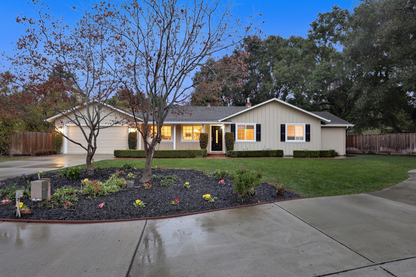 a front view of a house with a garden
