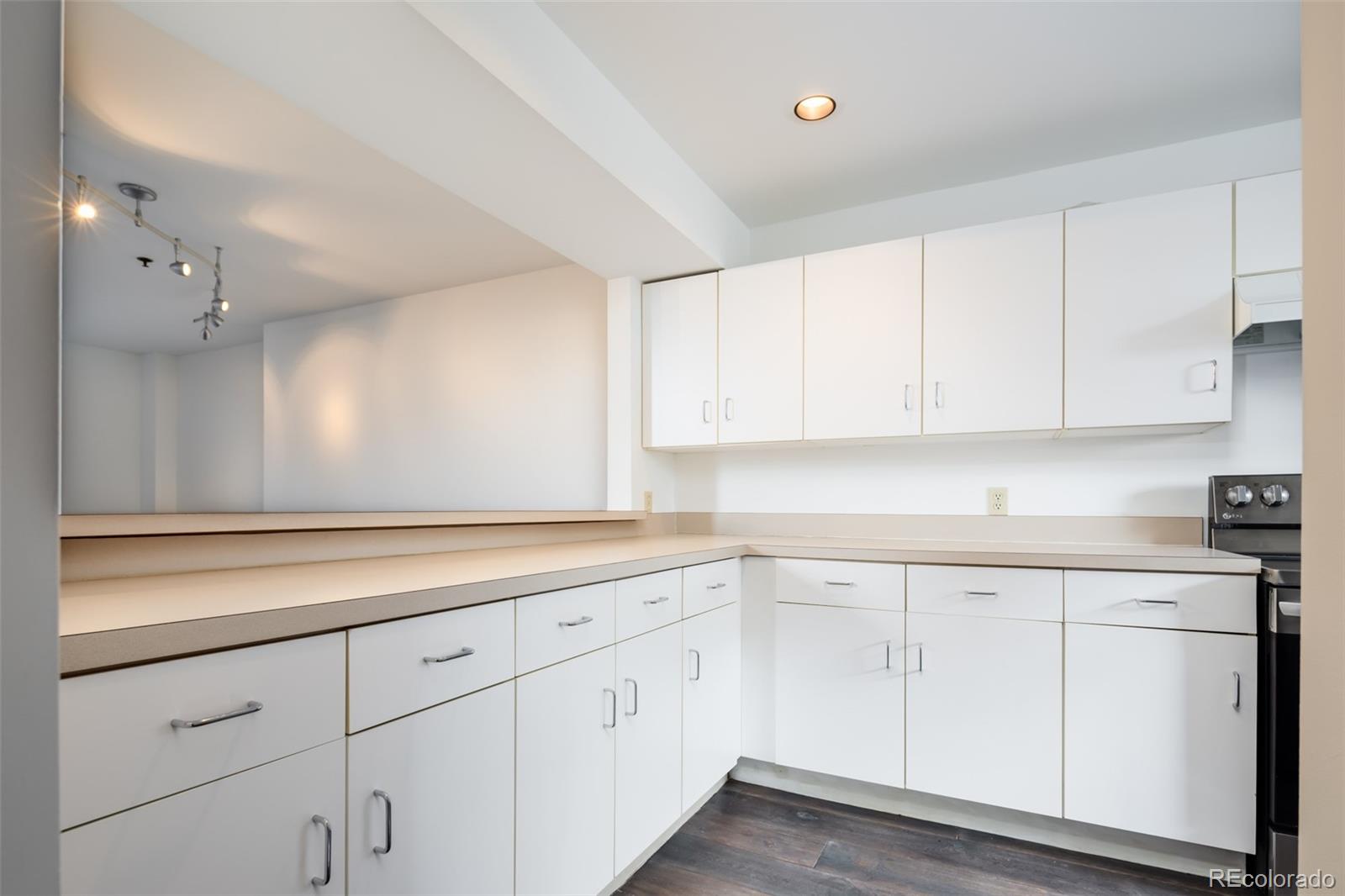 930 Acoma Street, Unit 212 Denver, CO 80204 - Photo 13 of 35 a kitchen with white cabinets white appliances and sink