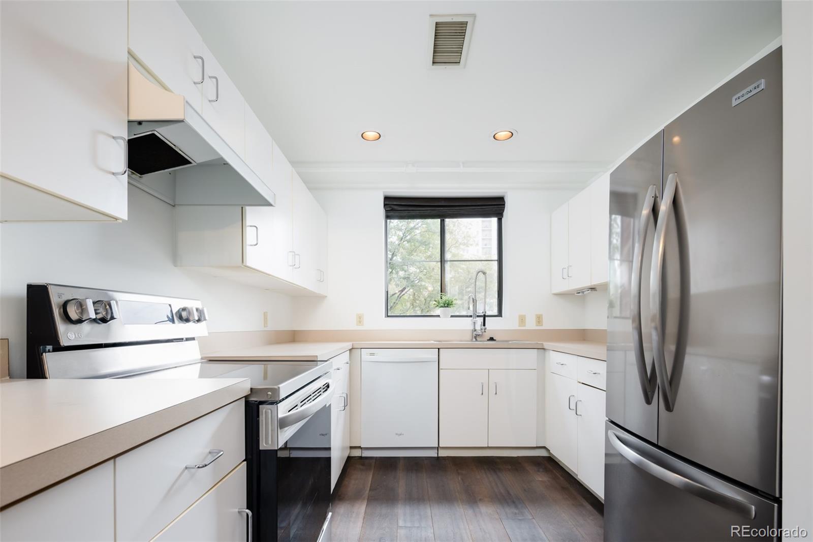 930 Acoma Street, Unit 212 Denver, CO 80204 - Photo 14 of 35 a kitchen with a sink a refrigerator and window