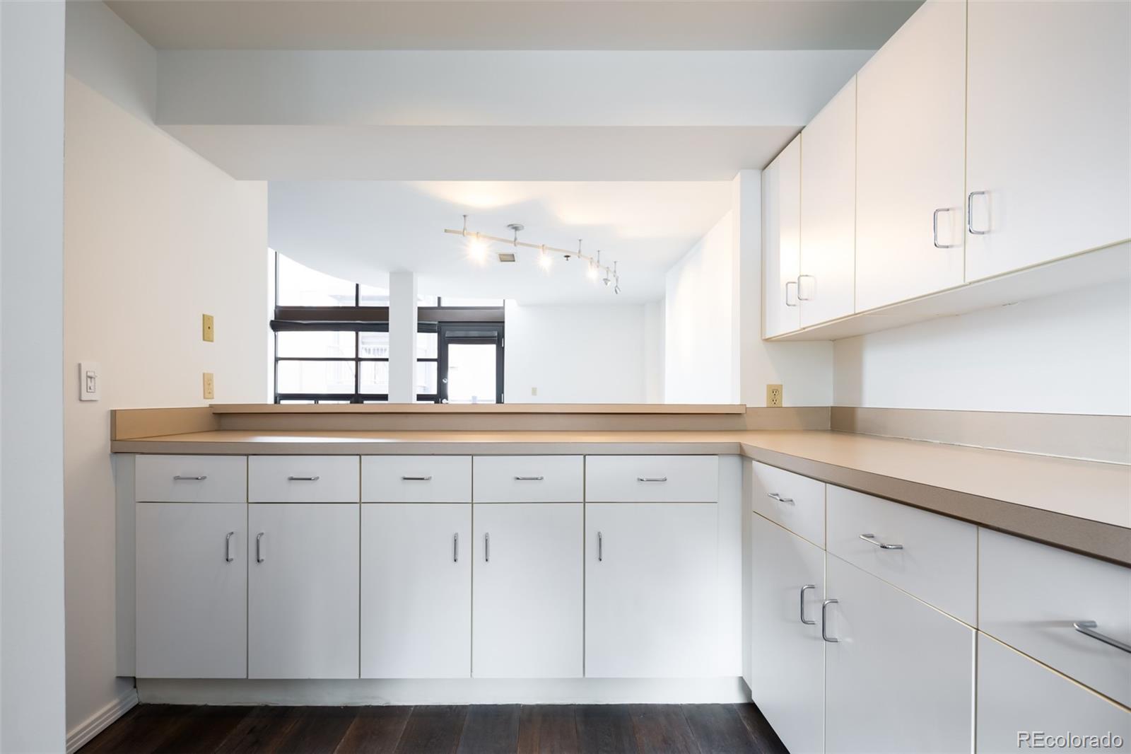 930 Acoma Street, Unit 212 Denver, CO 80204 - Photo 16 of 35 a kitchen with white cabinets
