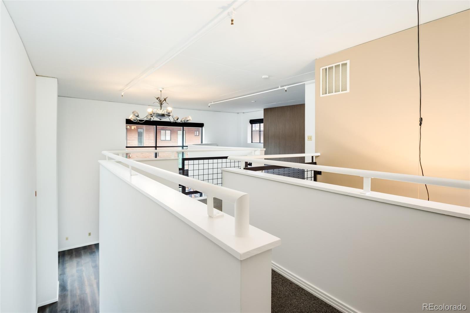 930 Acoma Street, Unit 212 Denver, CO 80204 - Photo 18 of 35 a kitchen with stainless steel appliances granite countertop a sink and a refrigerator