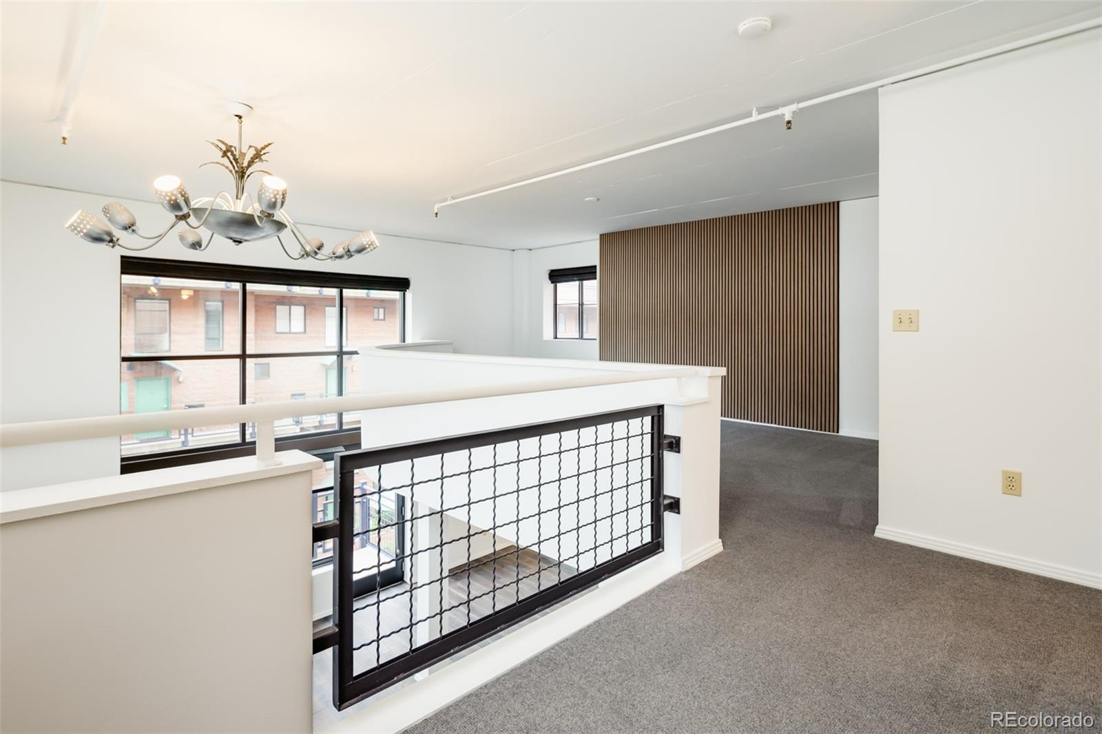 930 Acoma Street, Unit 212 Denver, CO 80204 - Photo 19 of 35 a bedroom with a bed and a dresser