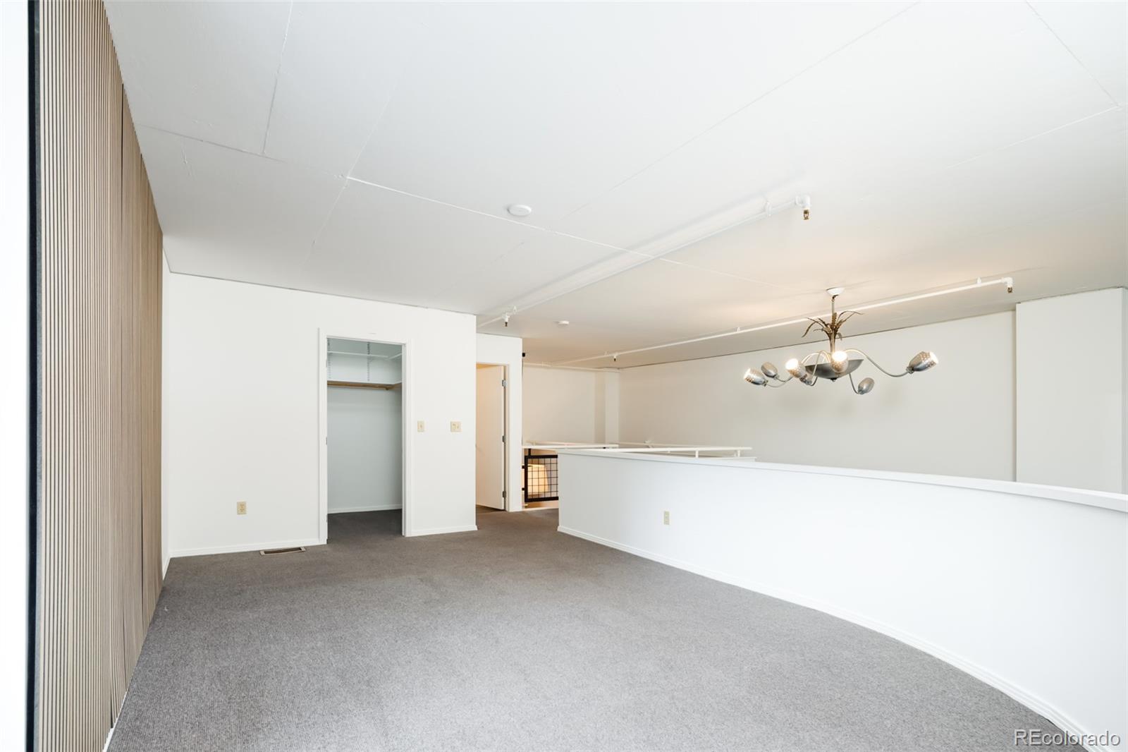 930 Acoma Street, Unit 212 Denver, CO 80204 - Photo 23 of 35 a view of a big room with chandelier fan and windows