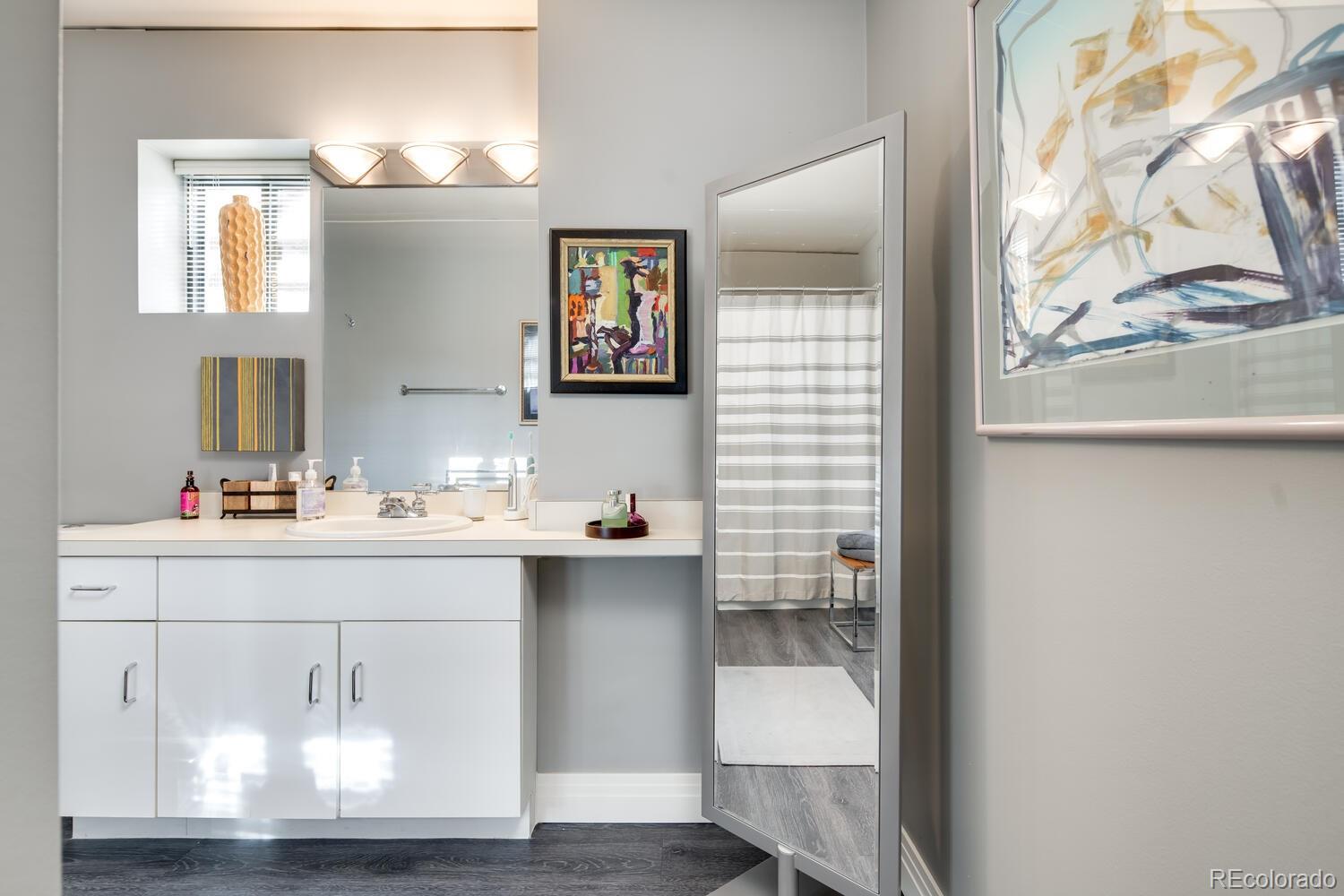 930 Acoma Street, Unit 212 Denver, CO 80204 - Photo 25 of 35 a bathroom with a sink and a mirror