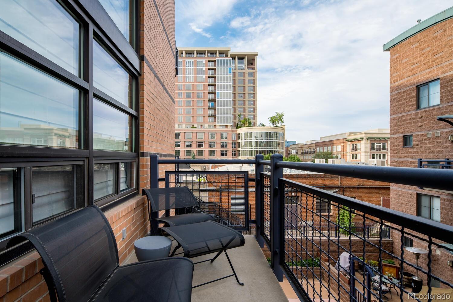 930 Acoma Street, Unit 212 Denver, CO 80204 - Photo 28 of 35 a view of a balcony with chairs