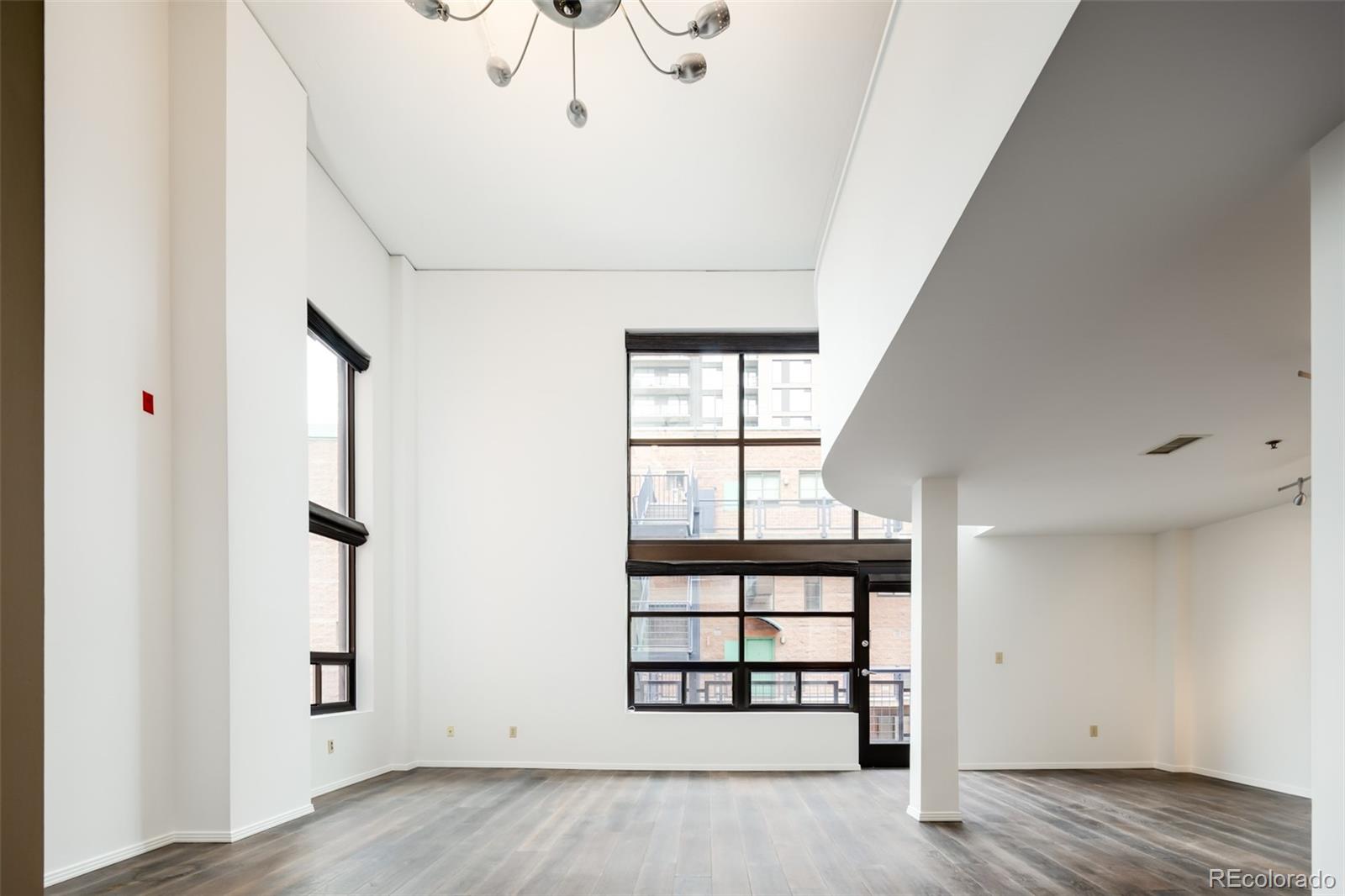 930 Acoma Street, Unit 212 Denver, CO 80204 - Photo 3 of 35 wooden floor in an empty room with a window