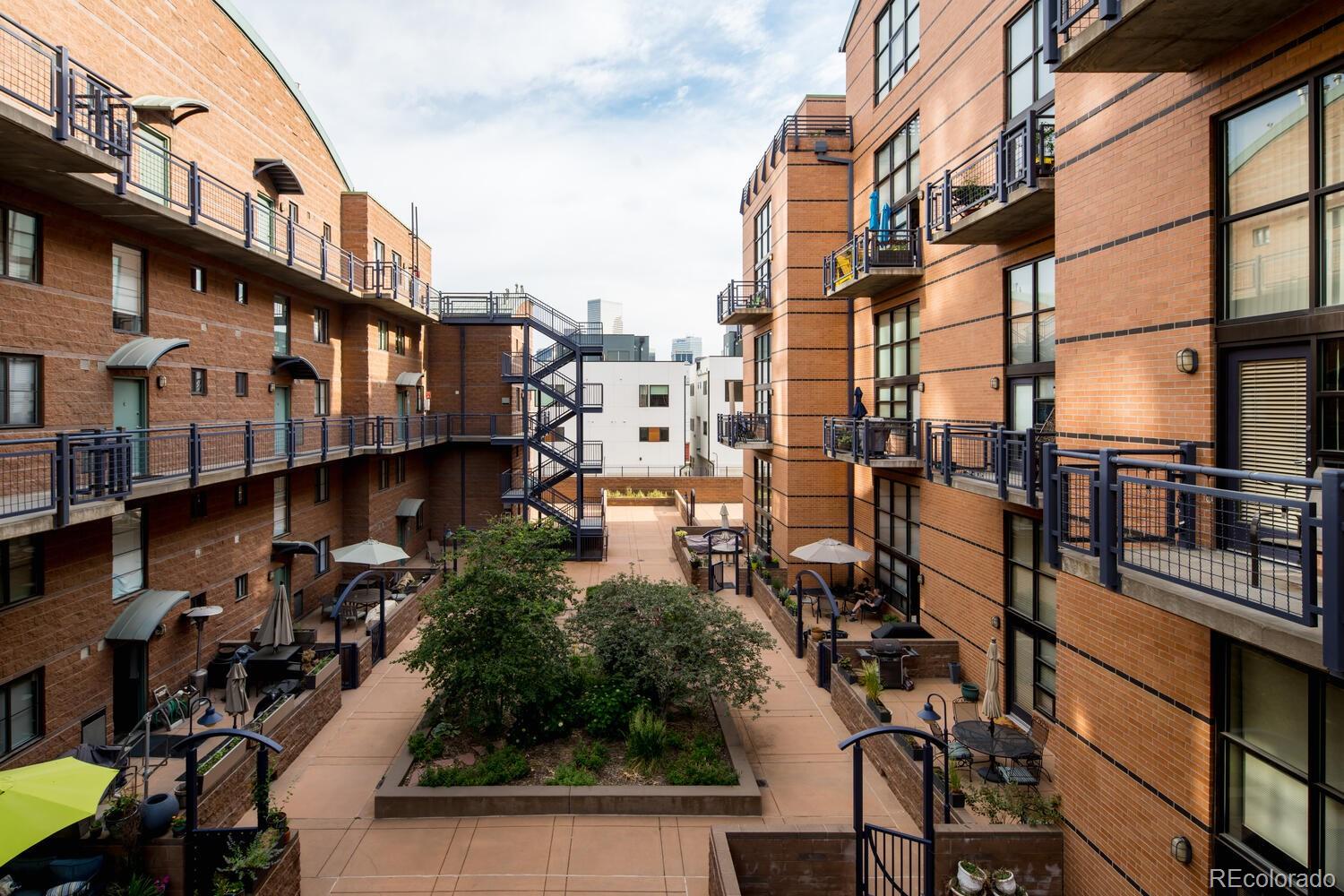 930 Acoma Street, Unit 212 Denver, CO 80204 - Photo 34 of 35 a city street lined with tall buildings