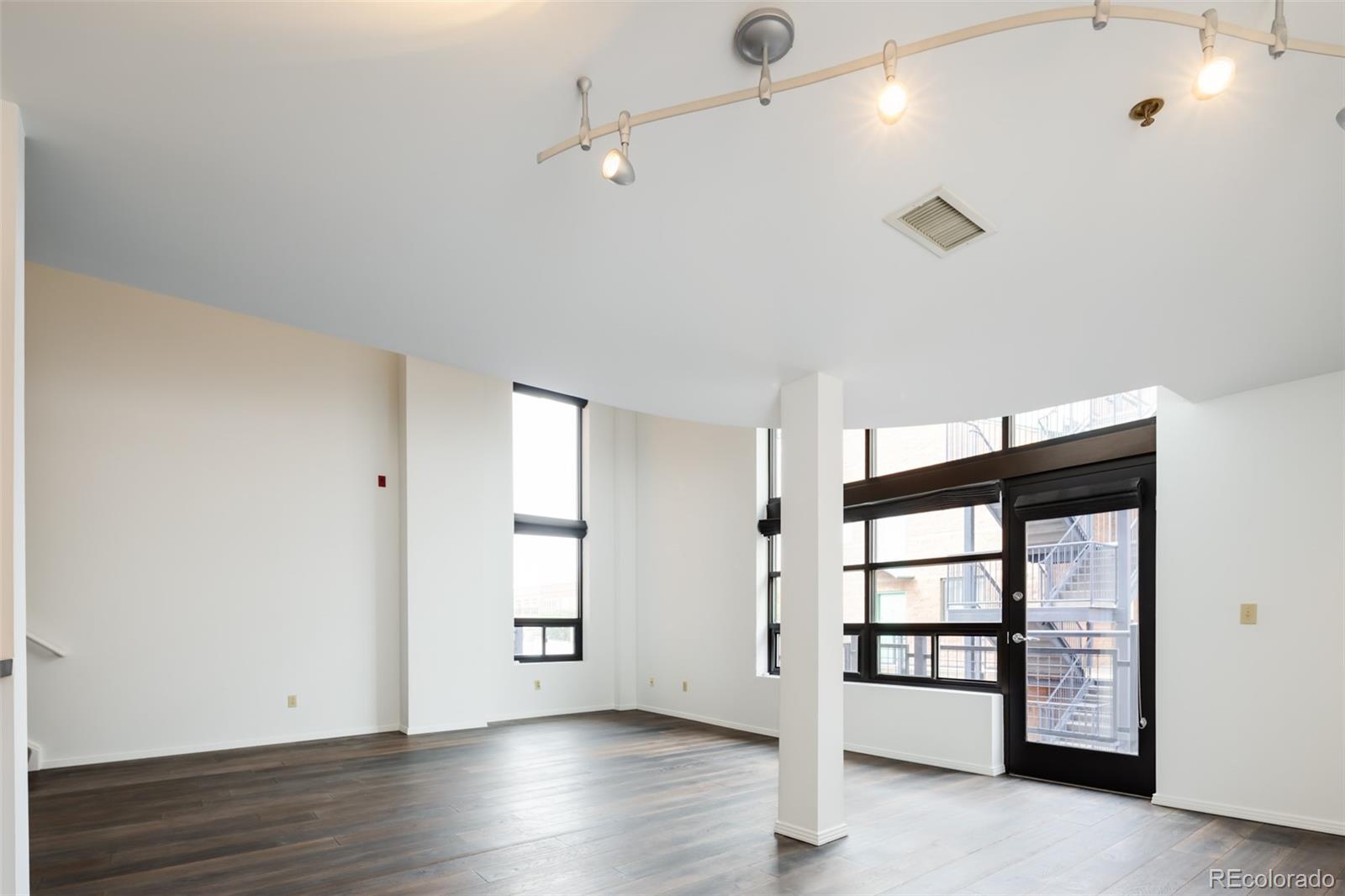 930 Acoma Street, Unit 212 Denver, CO 80204 - Photo 8 of 35 wooden floor in an empty room with a window