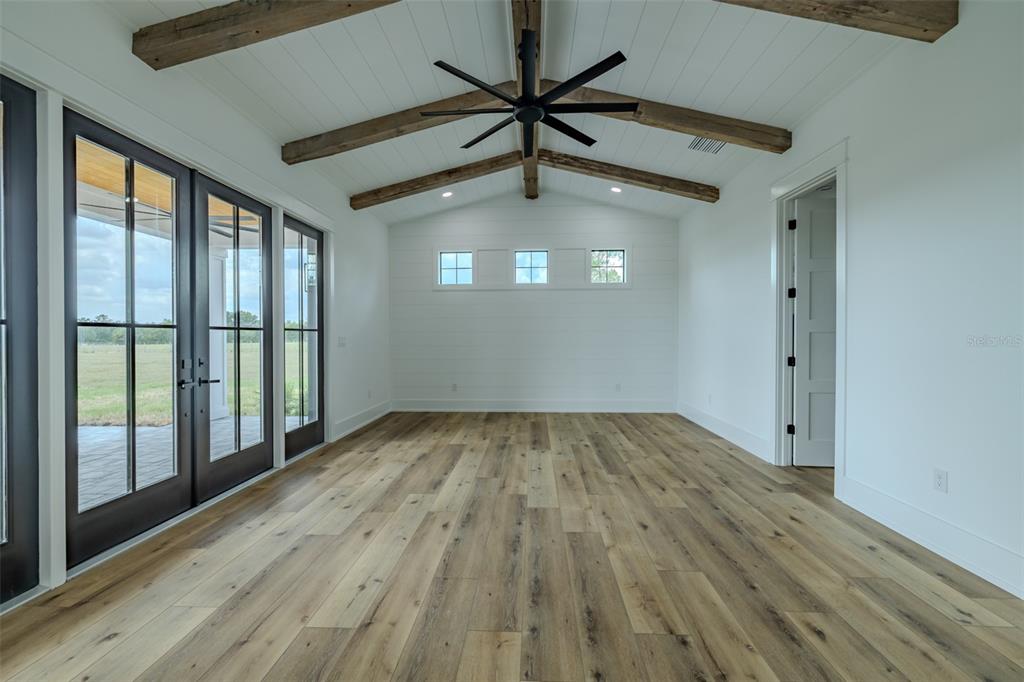 3515 Powerline Road Lithia, FL 33547 - Photo 42 of 100 a view of empty room with wooden floor and fan