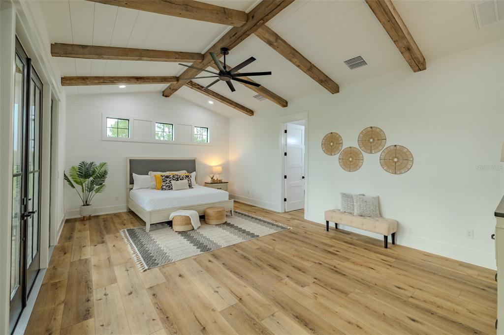 3515 Powerline Road Lithia, FL 33547 - Photo 44 of 100 a spacious bedroom with a bed and a chandelier