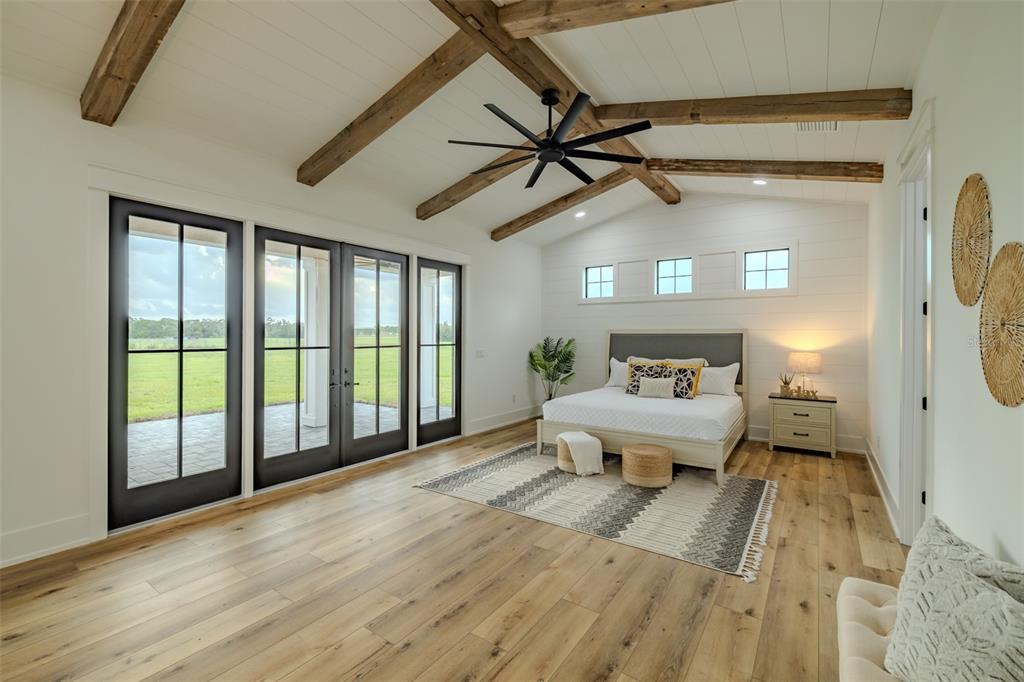 3515 Powerline Road Lithia, FL 33547 - Photo 45 of 100 a spacious bedroom with a bed and wooden floor