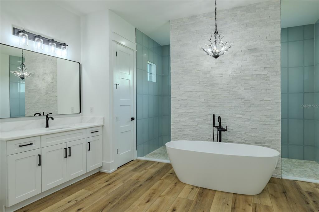 3515 Powerline Road Lithia, FL 33547 - Photo 55 of 100 a bathroom with a tub sink and mirror