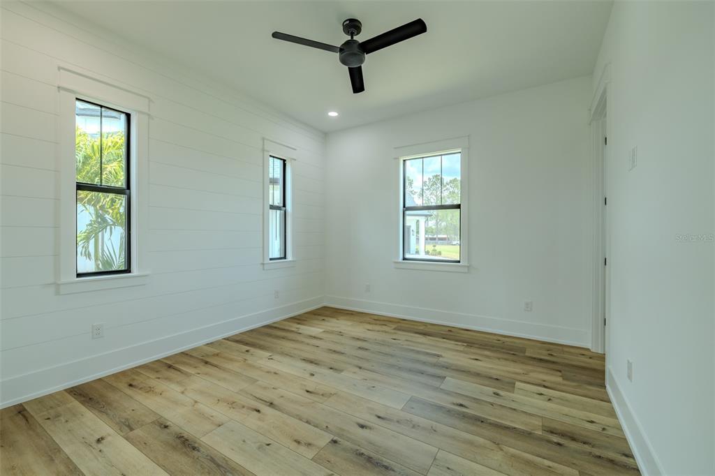 3515 Powerline Road Lithia, FL 33547 - Photo 63 of 100 a view of empty room with wooden floor and fan