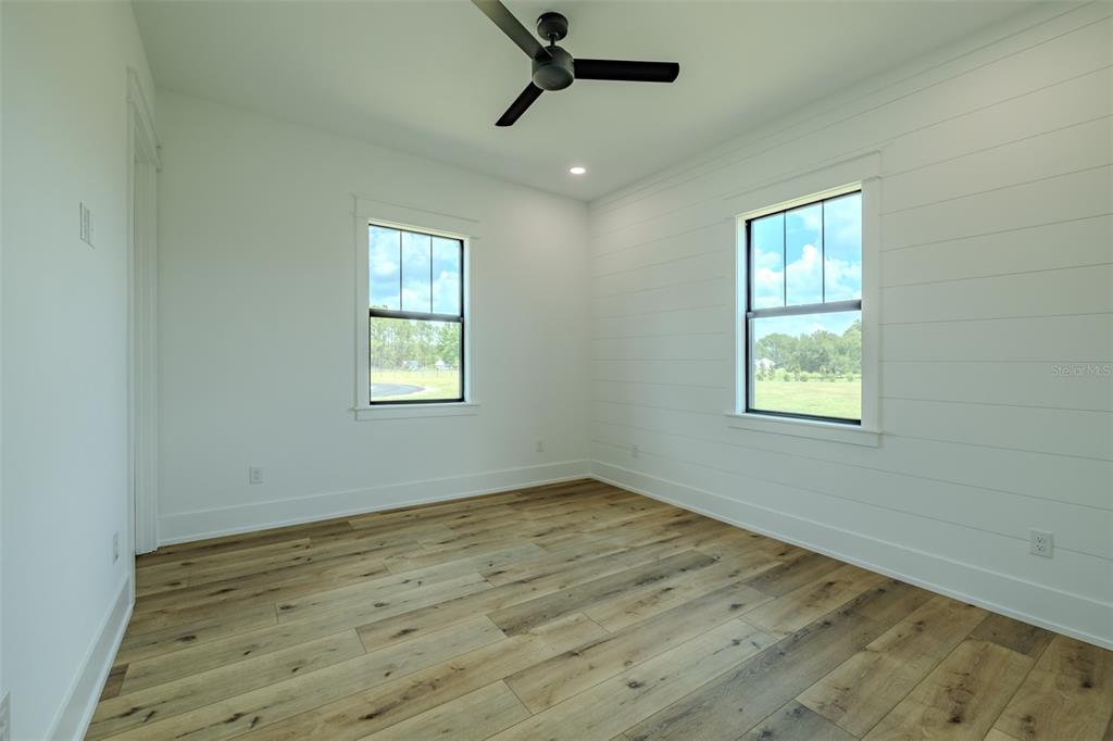 3515 Powerline Road Lithia, FL 33547 - Photo 66 of 100 a view of an empty room with wooden floor and a window