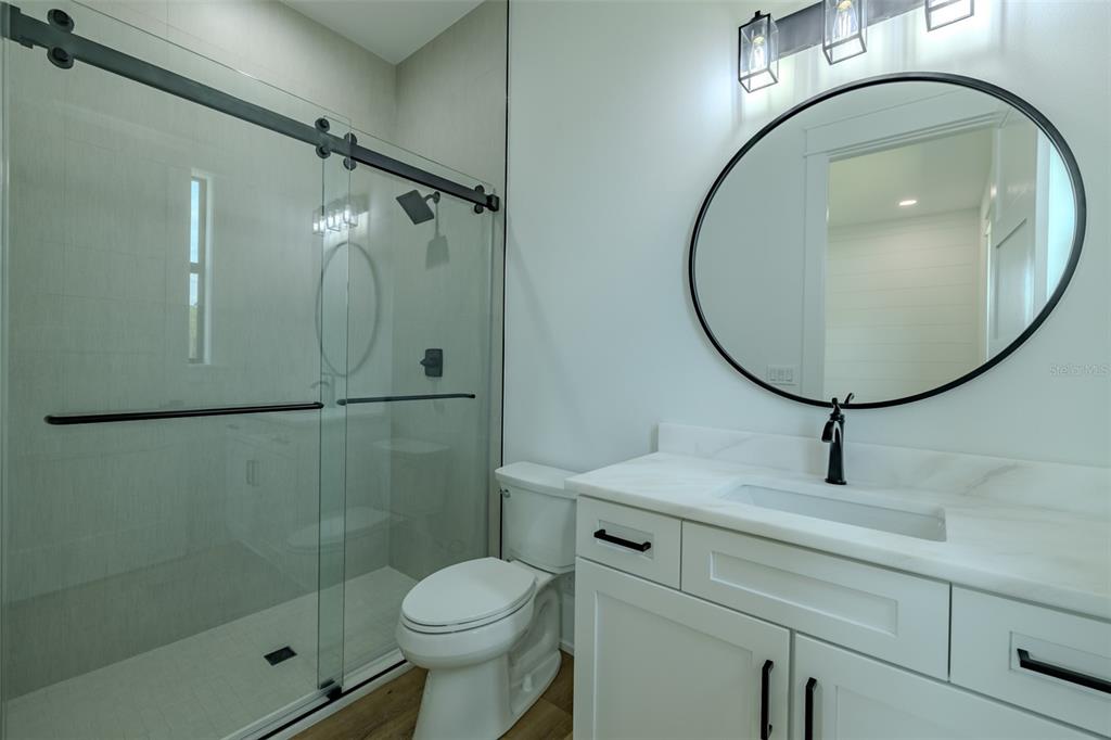 3515 Powerline Road Lithia, FL 33547 - Photo 68 of 100 a bathroom with a sink mirror toilet and shower