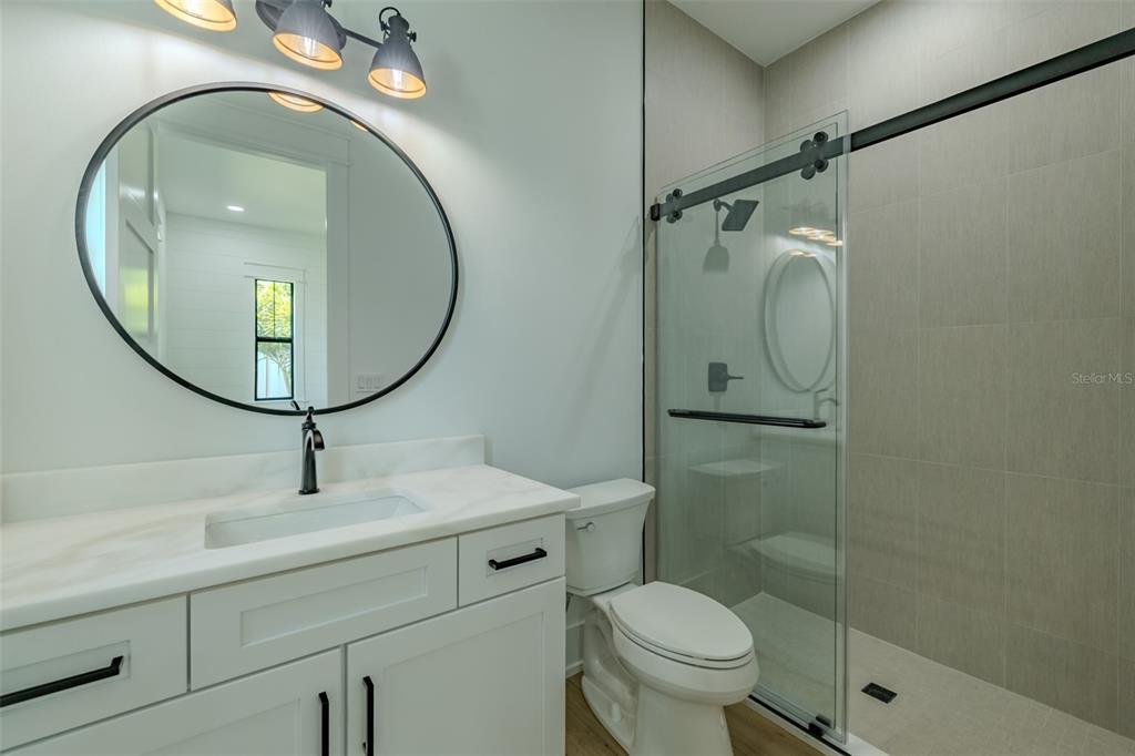 3515 Powerline Road Lithia, FL 33547 - Photo 69 of 100 a bathroom with a toilet sink vanity granite and a mirror