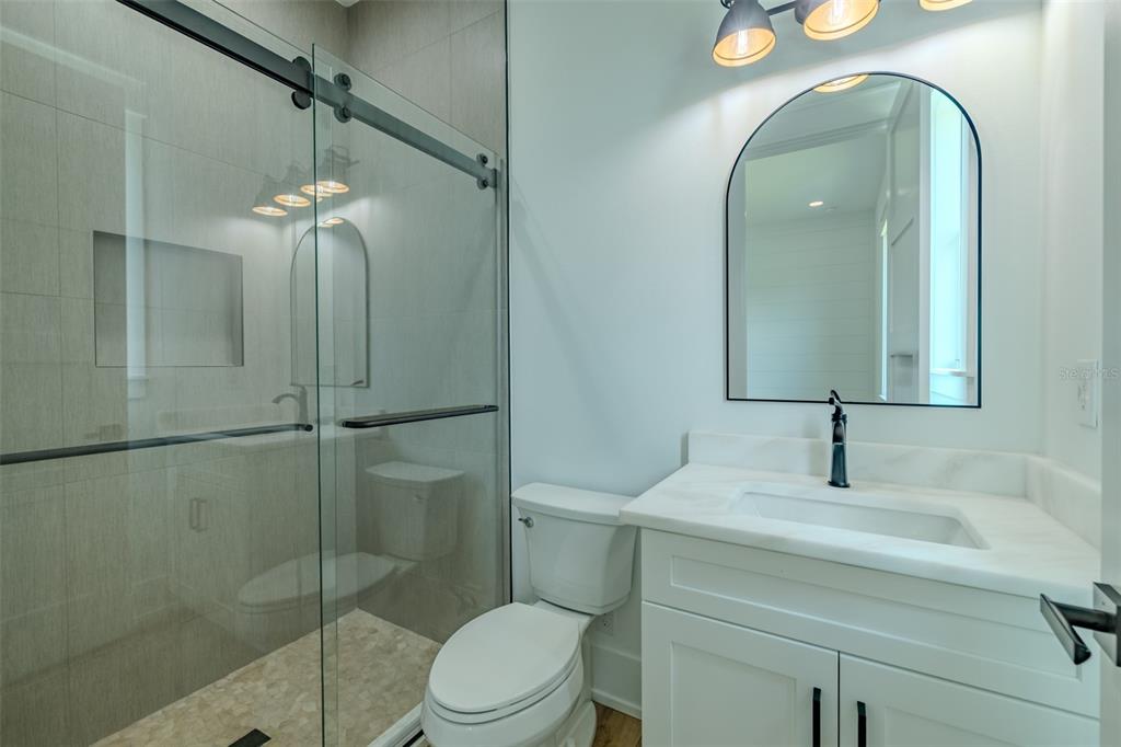 3515 Powerline Road Lithia, FL 33547 - Photo 72 of 100 a bathroom with a toilet a sink and shower