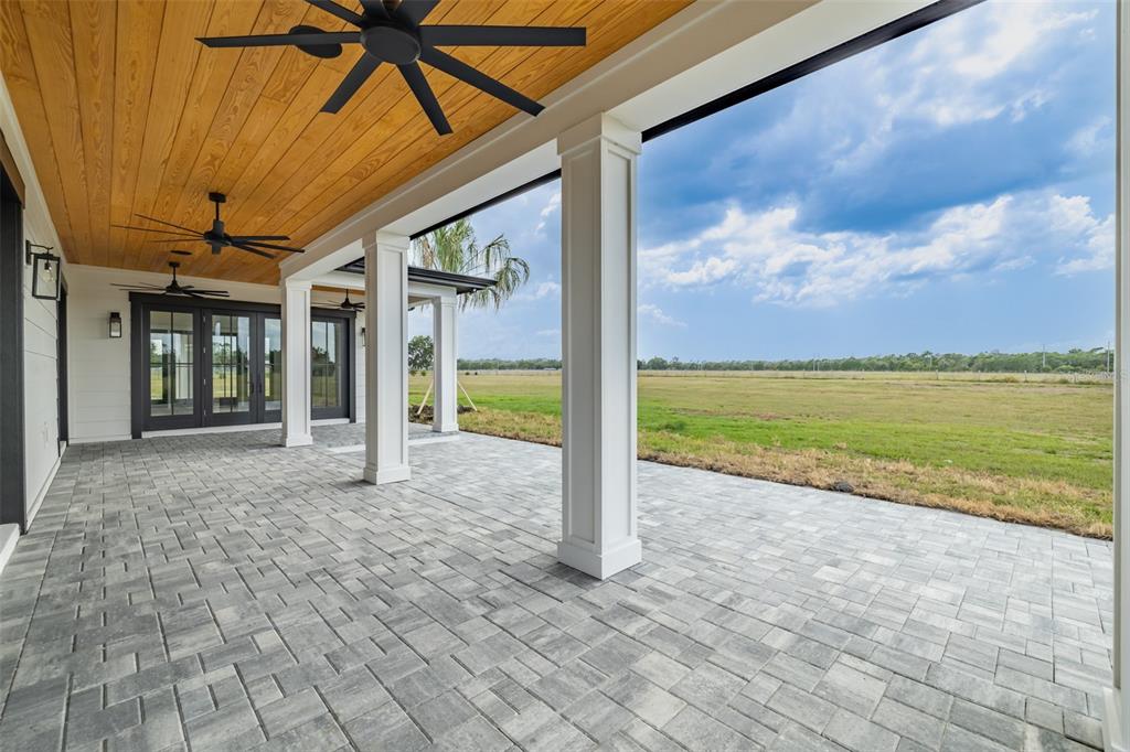 3515 Powerline Road Lithia, FL 33547 - Photo 90 of 100 a view of a room with wooden floor and a ceiling fan