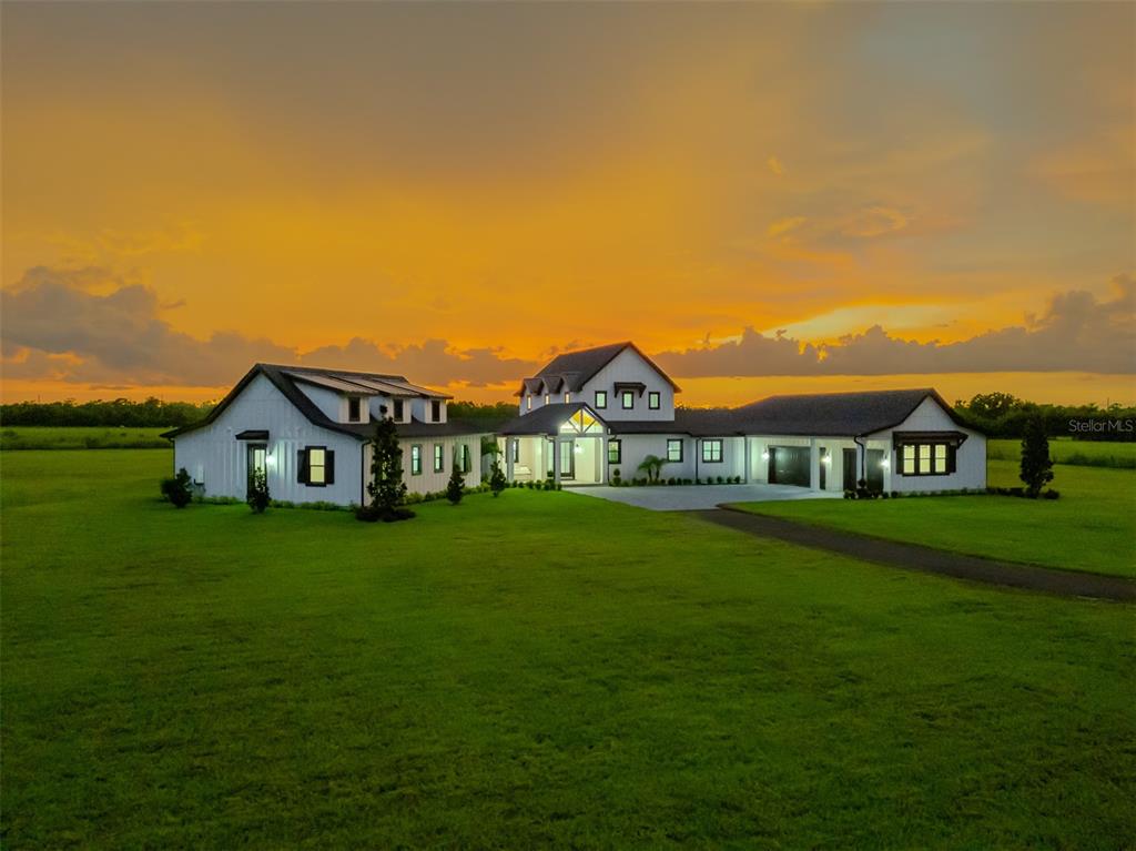 3515 Powerline Road Lithia, FL 33547 - Photo 94 of 100 a view of a big house with a big yard and large trees