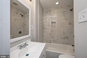2002 E Street Northeast Washington, DC 20002 - Photo 11 of 13 a bathroom with a bathtub shower sink vanity and a toilet