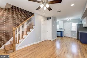 2002 E Street Northeast Washington, DC 20002 - Photo 3 of 13 a view of an empty room and kitchen view with wooden floor